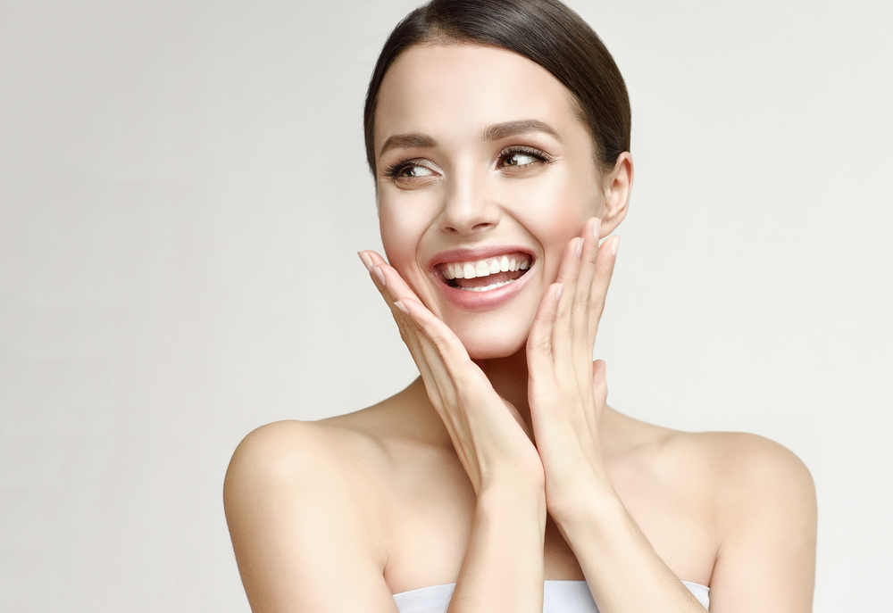 A woman with radiant skin smiling confidently after an IPL treatment.