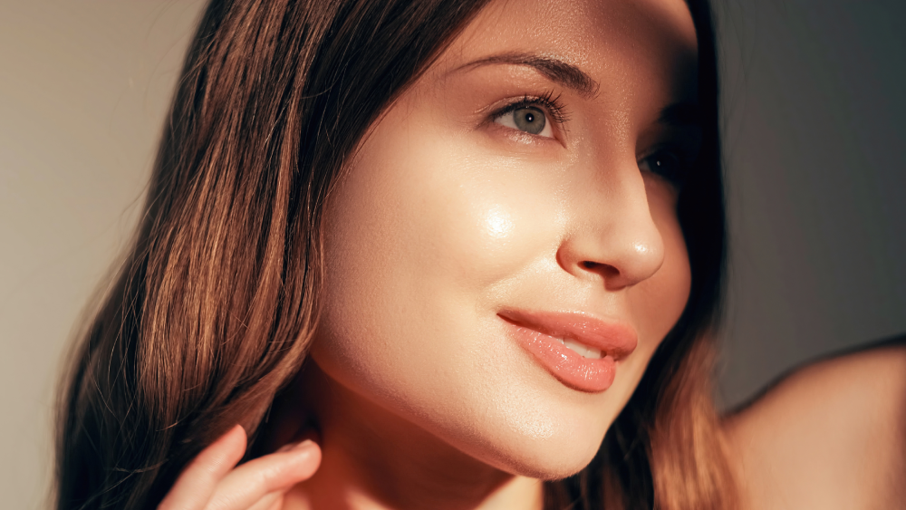 Woman with glowing skin after injectables treatment.