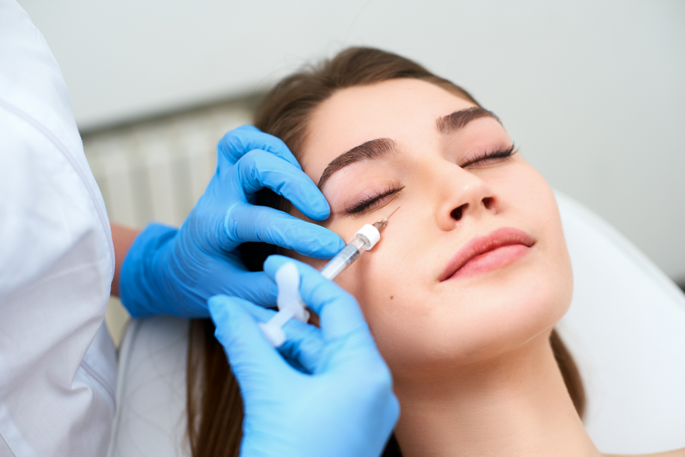 Injectable filler being administered under the eye.